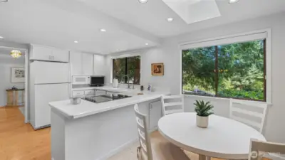 Extended bar seating adds versatility to this bright kitchen and inviting dining nook.