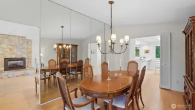 This elegant dining space with mirrored wall accents offers seamless flow into the living room