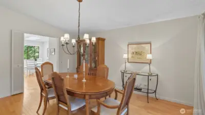 Spacious formal dining room designed for hosting, enhanced by warm wood tones and statement lighting.