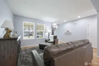 Door on the right is the convenient 1/2 bath; staircase to upper level is seen center photo.