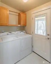 Laundry room with exit to a covered back deck