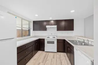 Great size for this recently updated kitchen.  New flooring, new countertops, new paint, new lighting.  Very open and bright with a see through to the dining/living room.