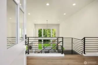 An impressive entryway opens up to tall ceilings and a wall-of-windows.