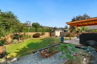 Raised garden beds and functional storage shed.