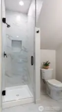 Fully tiled shower and flooring in 3/4 bath on lower level.