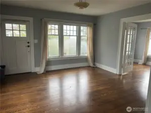 Generous light-filled living room with adjoining dining/flex room
