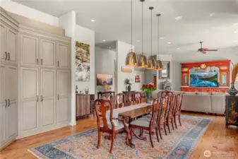 Sophisticated dining space highlighted by rich hardwood flooring, striking pendant lighting, and custom built-in cabinetry, designed to complement the home’s open and inviting layout.