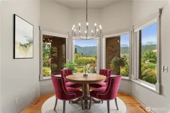 Inviting informal dining space with wraparound windows showcasing valley views.
