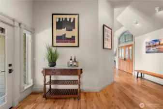 Bright interior hallway featuring hardwood flooring and classic Craftsman-style millwork that adds warmth and character throughout the home.