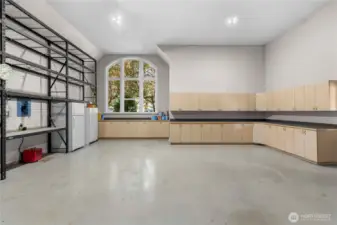 Well-equipped garage with custom storage cabinets, extended work counters, and large shelving systems—perfect for hobbies, tools, and organized storage.