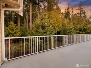 Overlooking a lush native forest of evergreens, the private deck offers a peaceful, natural backdrop and serves as the inspiration behind the home’s custom mural.