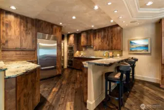 Thoughtfully designed, the kitchen showcases DeWils knotty alder cabinetry and granite countertops, creating a warm and inviting space.