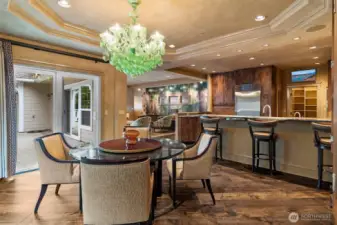 A Murano glass chandelier serves as a striking focal point, known for its handcrafted artistry and timeless Italian design.