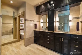 Natural stone flooring and thoughtfully placed lighting create a warm, spa-like atmosphere.