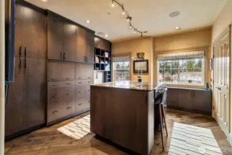 Currently used as a home office, this space features custom DeWils cabinetry and a built-in partner’s desk with granite counter, while easily converting into a comfortable guest bedroom when needed.
