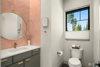 Custom pink tiles show off this half bath located directly off living room.