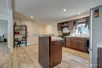 Lovely and open kitchen with breakfast bar.  Cook and have room to visit! Canned lighting lends to a bright and cheery home.