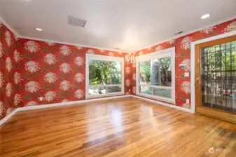 Living room has nice large windows that let in natural light.