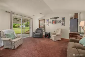 2nd Living room with sliding door to back patio and three steps up to the kitchen