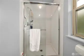 Large walk in shower with built in storage in the primary suite