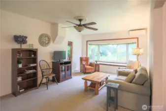 Cozy living room with sweet window seat.  Mini splits in the living room and dining room provide warmth on cold winter days and air conditioning on those hot summer nights.