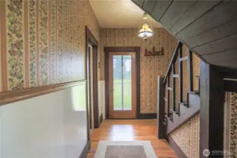 The nostalgic back entry, with its unique character, leads to the back porch, then upstairs to the finished attic space ready for your home office or den, making this a great combination of vintage and updated charm.