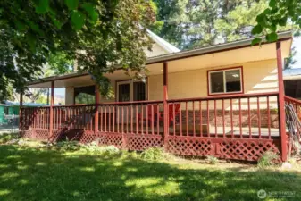 2 Bed 2 Bath home on 1 fenced Acre offers 1,148 sf on one level. Brick fireplace with Petrified wood features. Electric heat and cooling. Kitchen has wood cabinets. Light and bright. Counter space and breakfast bar. Linoleum floors. Tile backstop. Primary Bedroom is wall to wall carpet. Built in closet and drawers. Full bath. Second bedroom carpeted. 3/4 Bath. Utility room. Large pantry. New Hot Water tank. Washer/Dryer included. 2 vehicle carport. Paved driveway. Large Shop /Garage 1772 sf. Additional outbuildings.