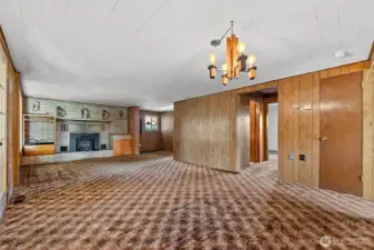 Living room and dining room share big picture windows looking out at Treed yard beauty.