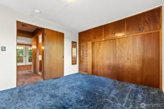Primary Bedroom Built in dressers and closet.