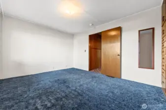 Primary bedroom is carpeted. Built-ins wood dressers and closet. Full bath.