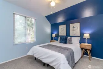 Second bedroom upstairs overlooks the backyard with ceiling fan.