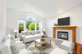 Light & bright Living Room feature large picture window & gas fireplace. Virtually staged.