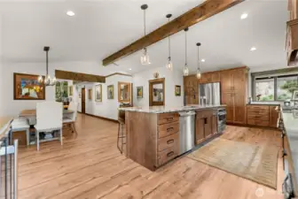A closer look at the built-in stainless steel oven and refrigerator reveals the kitchen’s seamless design, balancing convenience with high-end finishes.