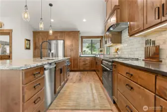 Expansive counter space is paired with deep drawers and upper cabinetry, providing organized storage while keeping the look clean and sophisticated.