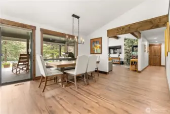 Enjoy seamless indoor-outdoor living with direct access to the covered patio from the dining area. The warm wood floors flow into the living room, where a stunning stone fireplace becomes the centerpiece of the home.