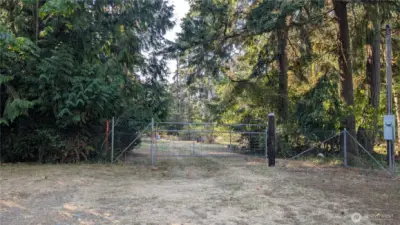 Gate is on access easement property. Flagged pole is NE corner of adjoining 1.21 acres that is also available. Not any kind of marker for this 1.25 acres