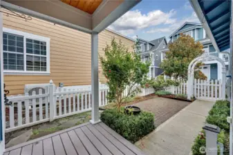 Rear covered porch with fenced courtyard