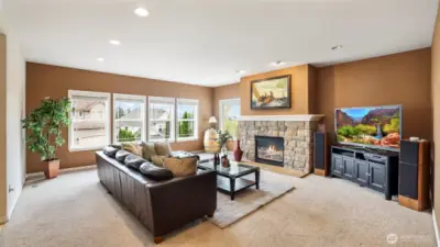 Enjoy this sun-filled living room with stone fireplace—perfect for relaxing or entertaining year-round.