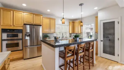 This kitchen features abundant cabinet storage and a stunning island with bar seating—perfect for entertaining.