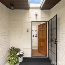 A sky-lit covered porch welcomes you home.
