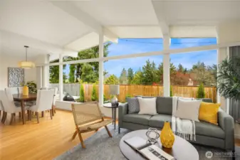 Exposed beams soar overhead, anchored by warm hardwood floors below.
