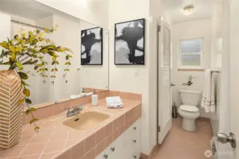Full guest bath with separate commode/shower room.