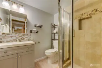 3/4 bathroom on lower floor has shower with built in shelf.