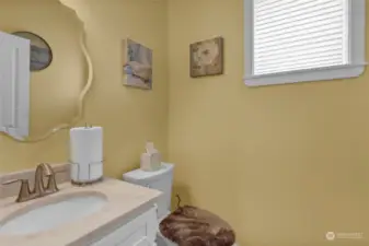 Powder Room Main Floor, Situated off the kitchen, next to the garage door.