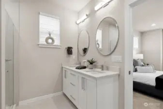 Primary bathroom with double sinks and separate mirrors.