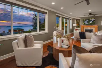 Perched on Marine View Drive, high above it  all, this home invites you to soak in the  splendor of spectacular sunsets and the  gentle rhythm of ferry boats gliding across  the water.