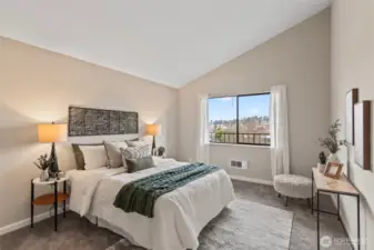 Inside the large bedroom, find lovely vaulted ceilings.