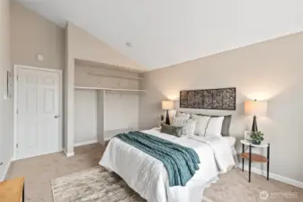 The bedroom has a great closet alcove with storage shelves.