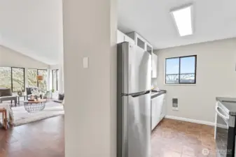 The kitchen and living areas as seen from the entry hall.