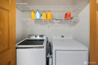 Convenient in-kitchen laundry with a dedicated washer and dryer tucked behind doors—efficiently designed for easy access while maintaining a tidy look.